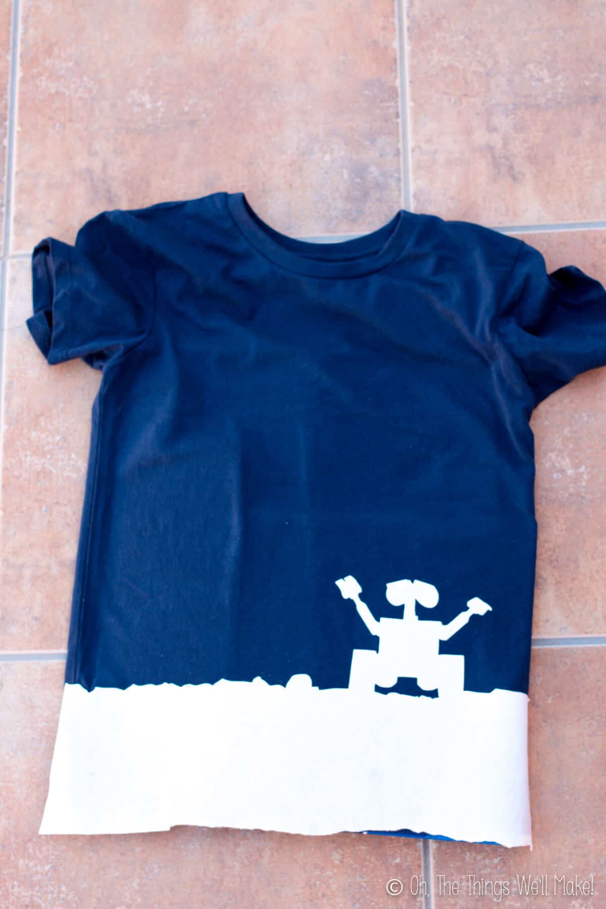 T-shirt with freezer paper stencil of Wall-E silhouette ironed onto the bottom.