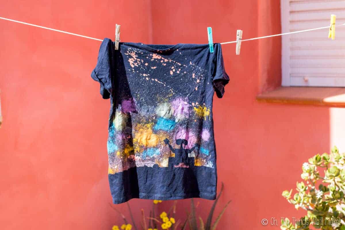 A newly finished galaxy Wall-E t-shirt after having been washed, hanging on a clothesline to dry