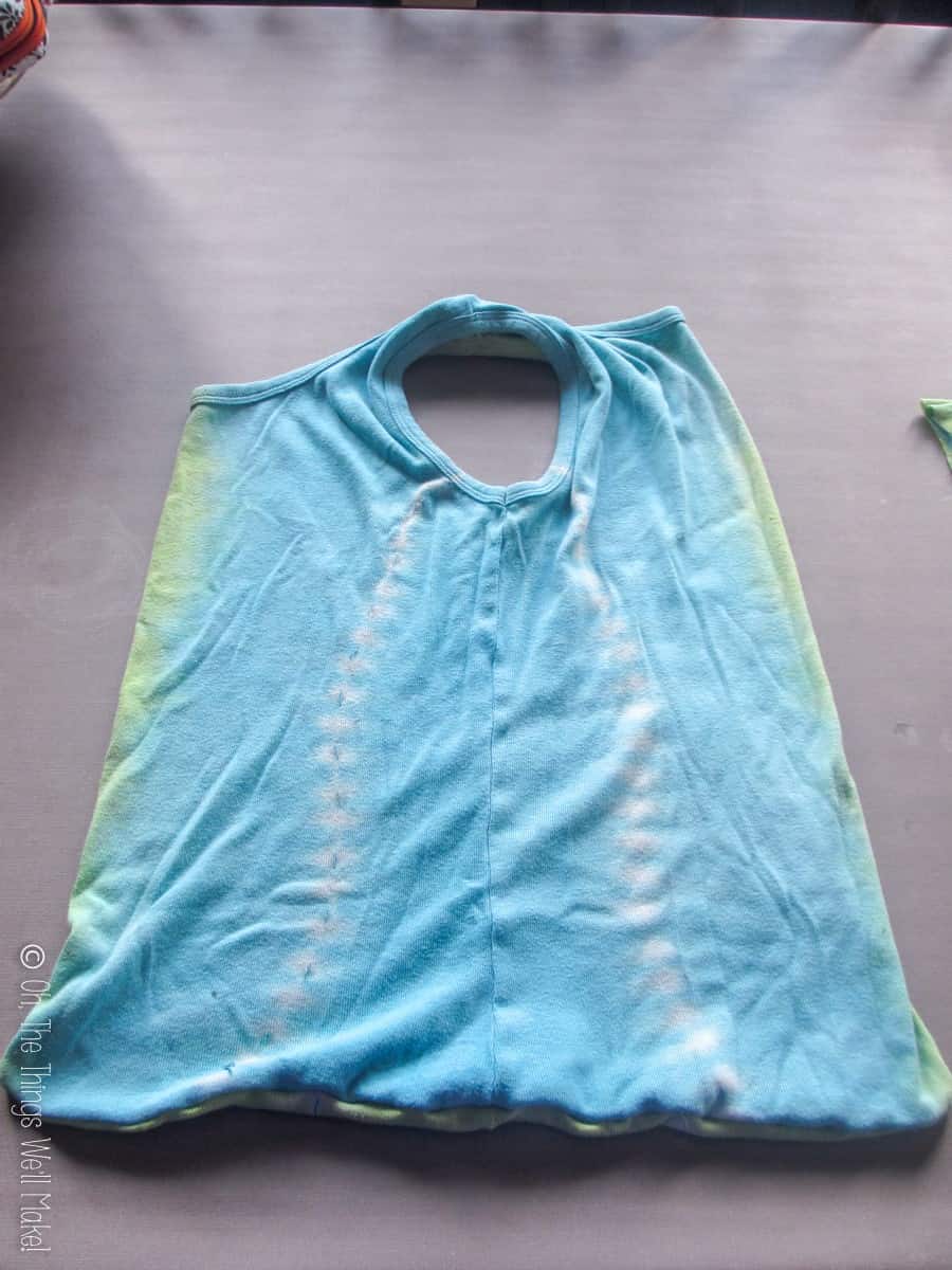 Top view of a tie dyed light blue and green t-shirt bag.