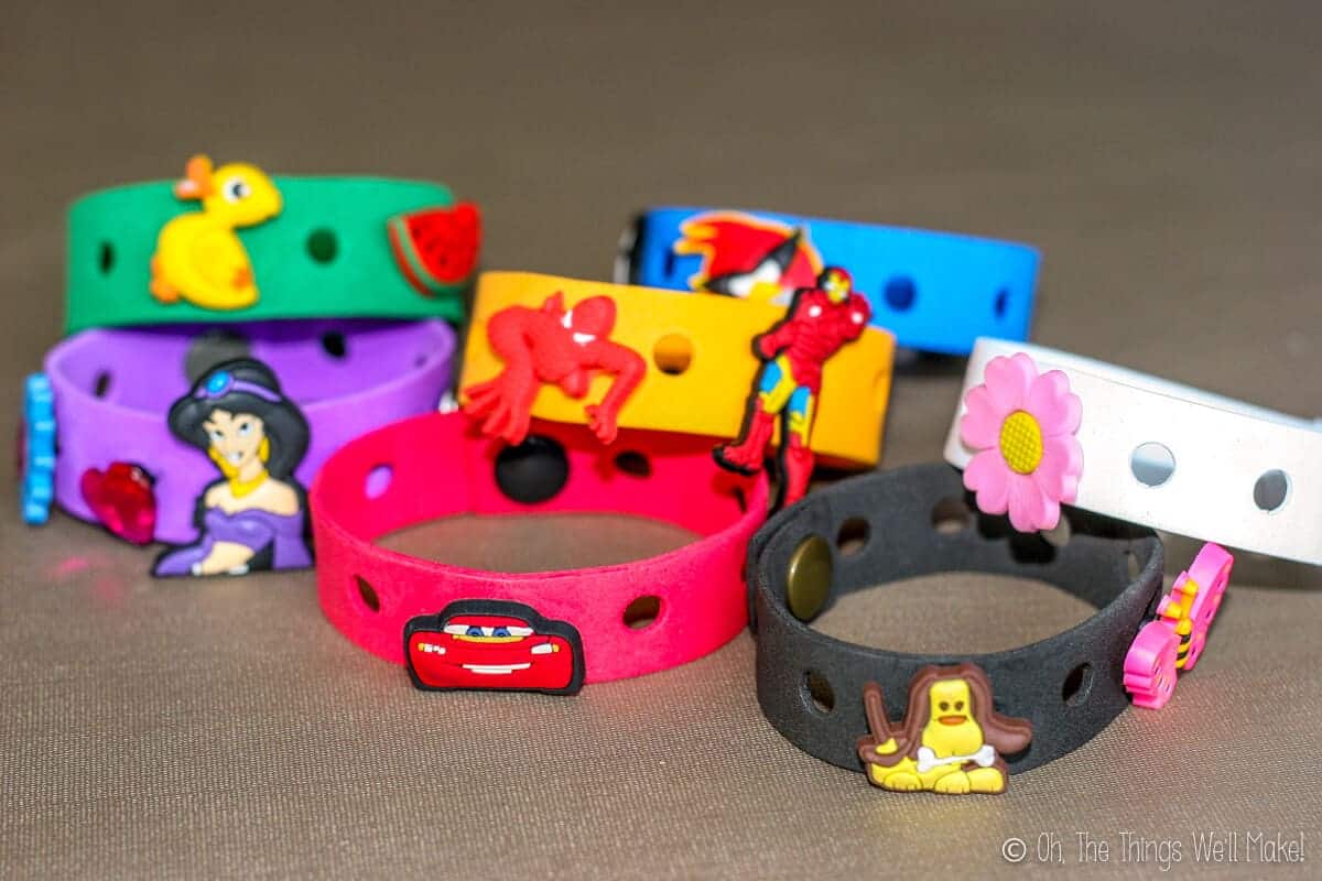 Close up of homemade colorful craft foam bracelets in several colors with Crocs charms (Jibbitz) on them.