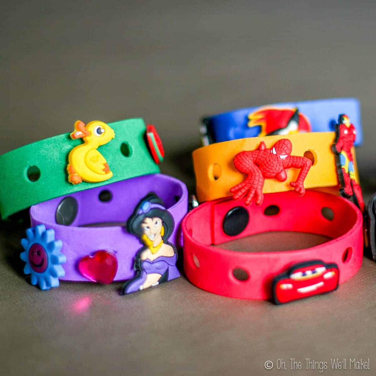 homemade craft foam bracelets in several colors with Crocs charms (Jibbitz) on them