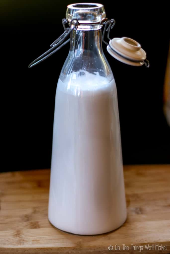 A glass bottle full of homemade white coconut milk.