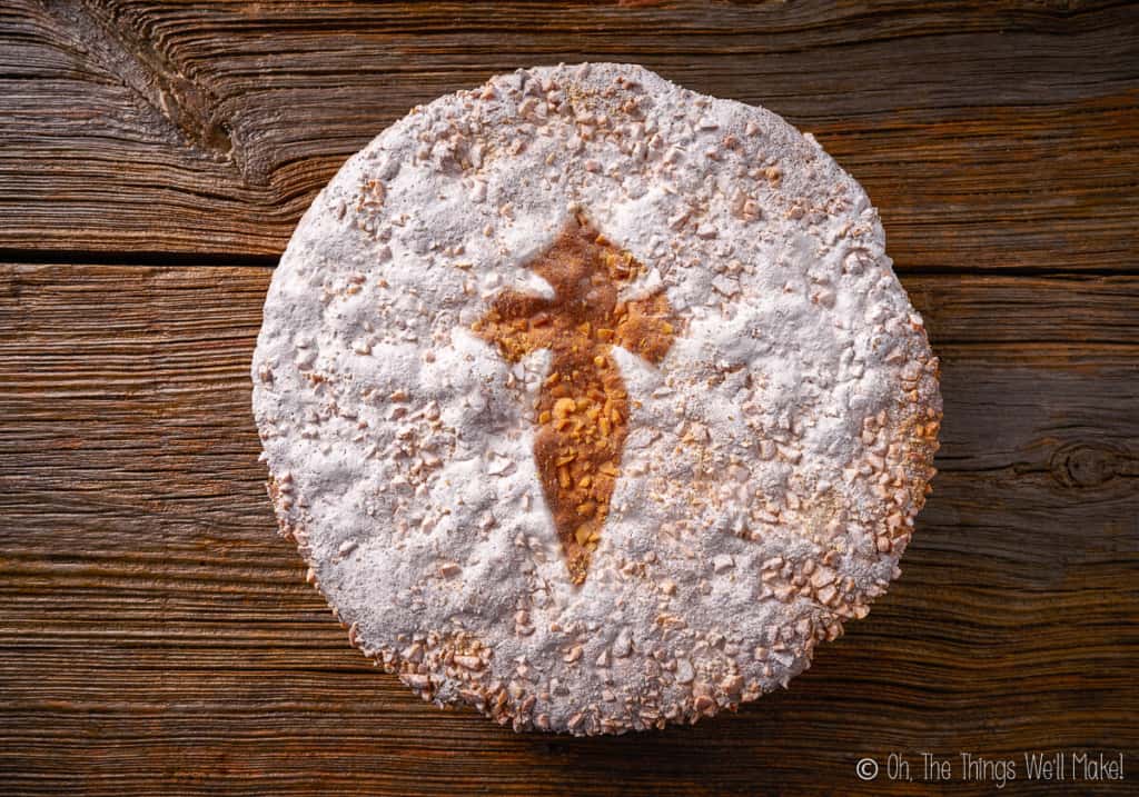 Top view of Tarta de Santiago (St. James cake). This cake is decorated with a cross in powdered sugar.
