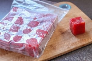 strawberry ice cubes stored in a freezer bag