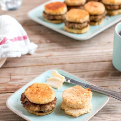 Delicious sausage patties in between homemade sausage biscuits with butter on the side.