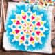 A cloth bag with a beautiful colorful mandala design painted on it with fabric paints.