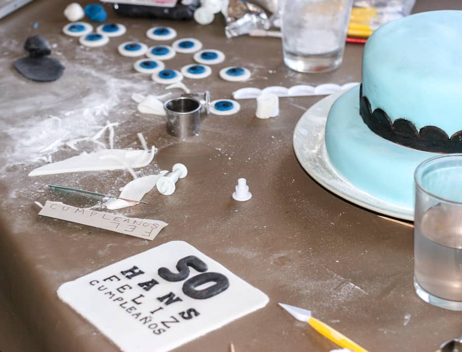 A fondant cake with a fondant eye chart and fondant circles in the foreground. 