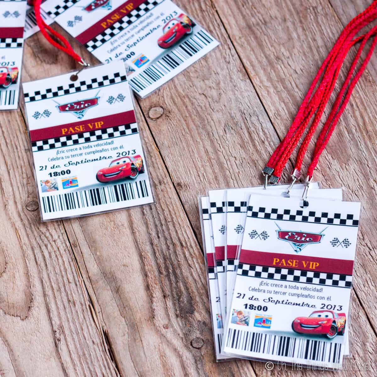 Cars party invitations that look like pit passes on lanyards.