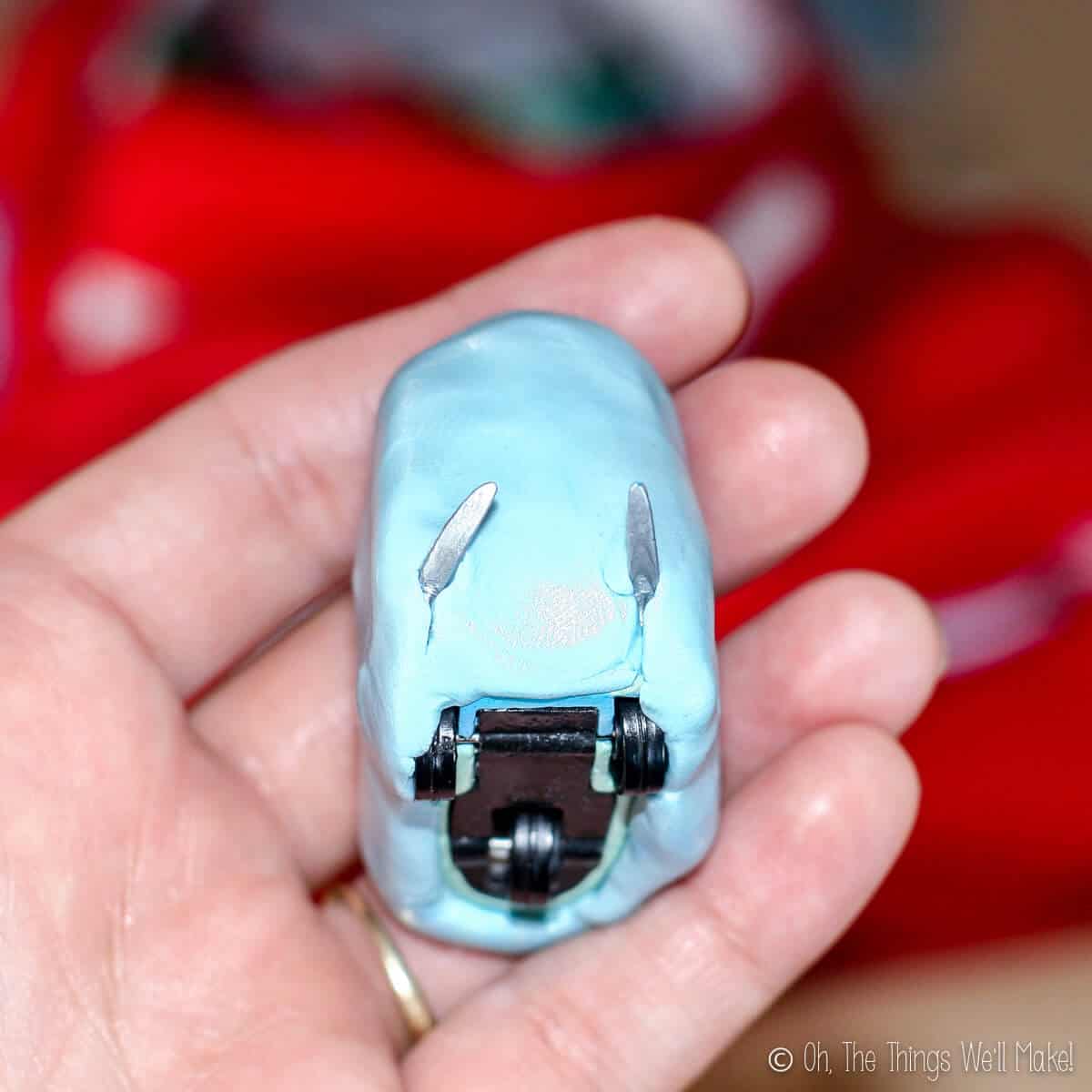 Close up of a car toy covered in silicone putty to make a mold for fondant.