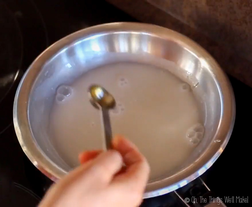 adding honey to a saucepan with coconut milk and gelatin