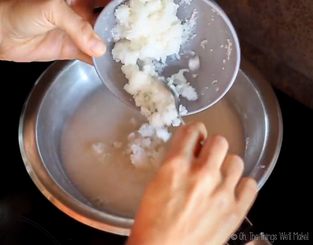 Adding gelatin to a pan with coconut milk