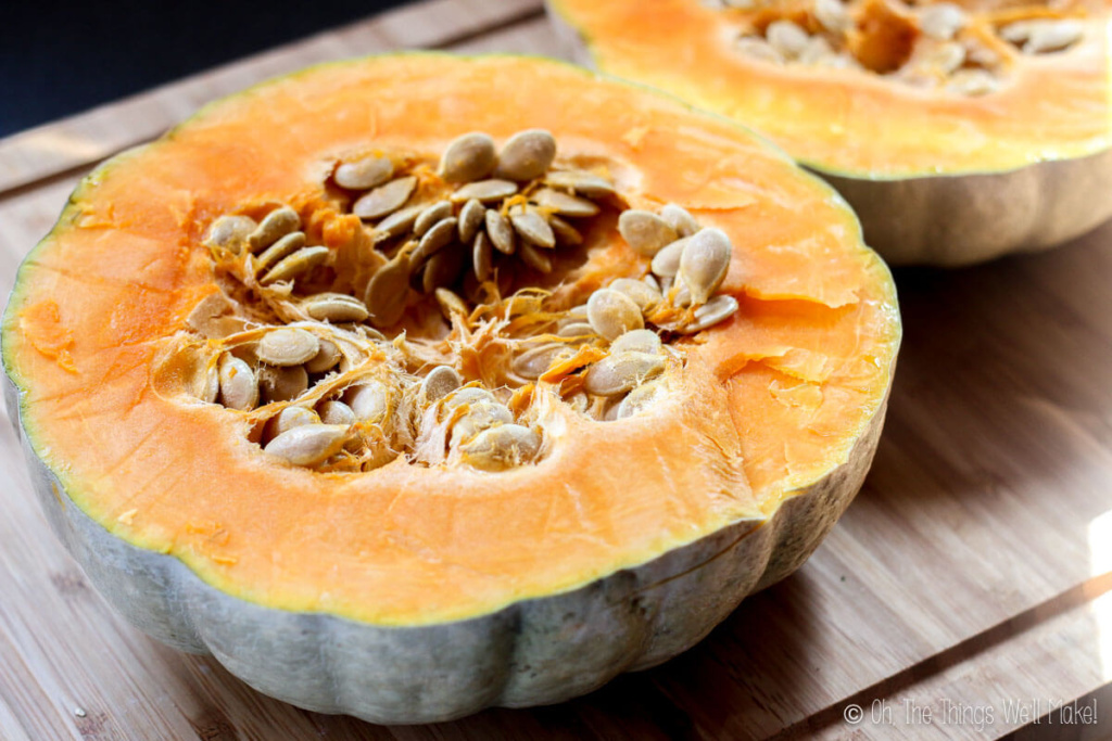 A round pumpkin cut in half across its width.