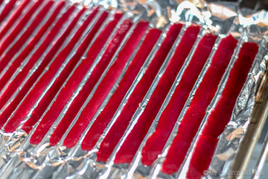 Red gelatin piped into valleys made by tin foil pressed between metal grill bars
