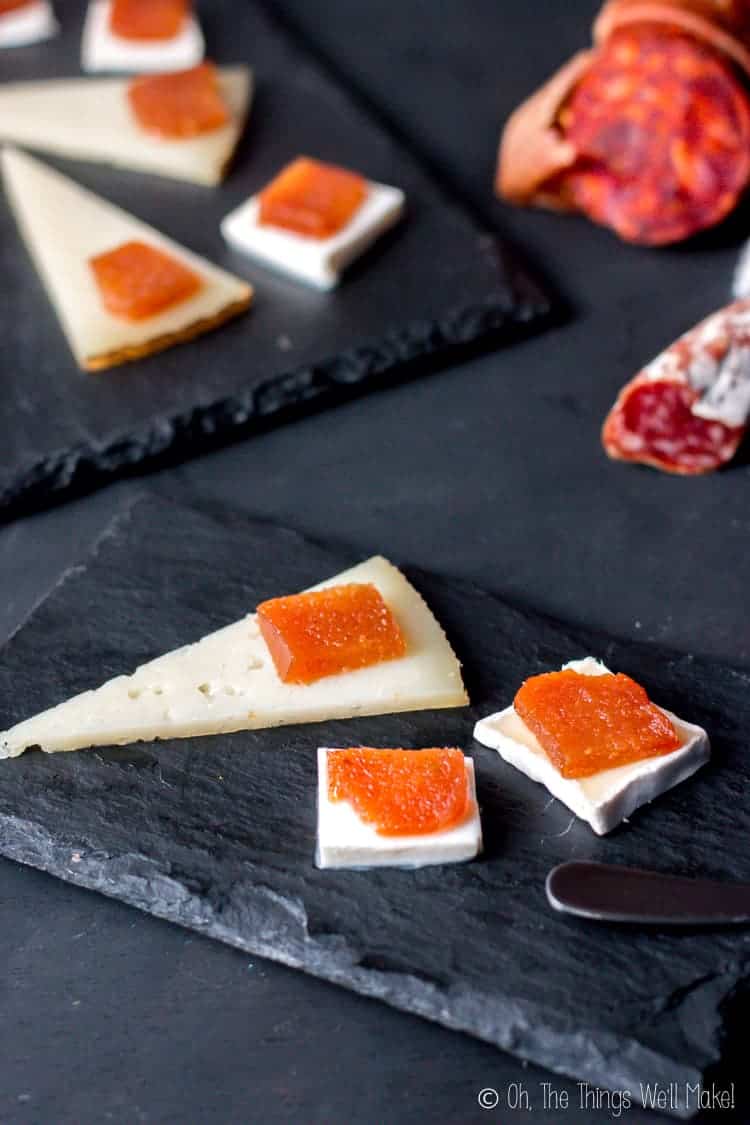 Slices of dulce de membrillo (also known as quince cheese) over slices of different types of cheese. 