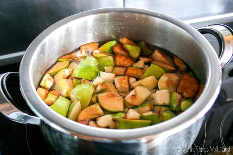 Boiling quince pieces in a pot of hot water