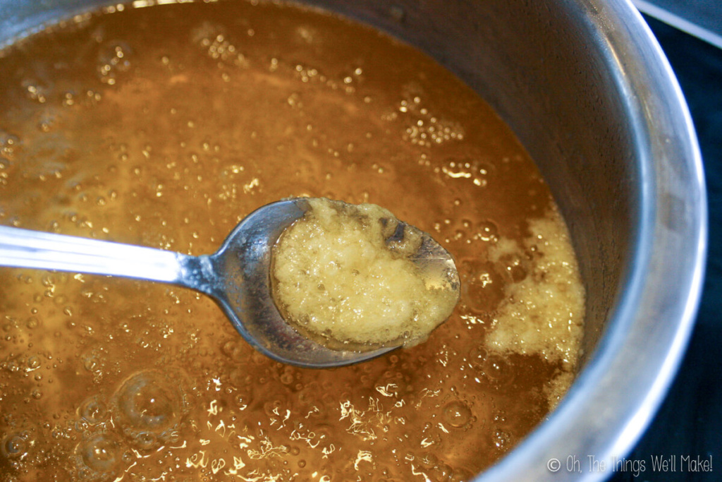 skimming the foam that rises to the top of the melted butter.