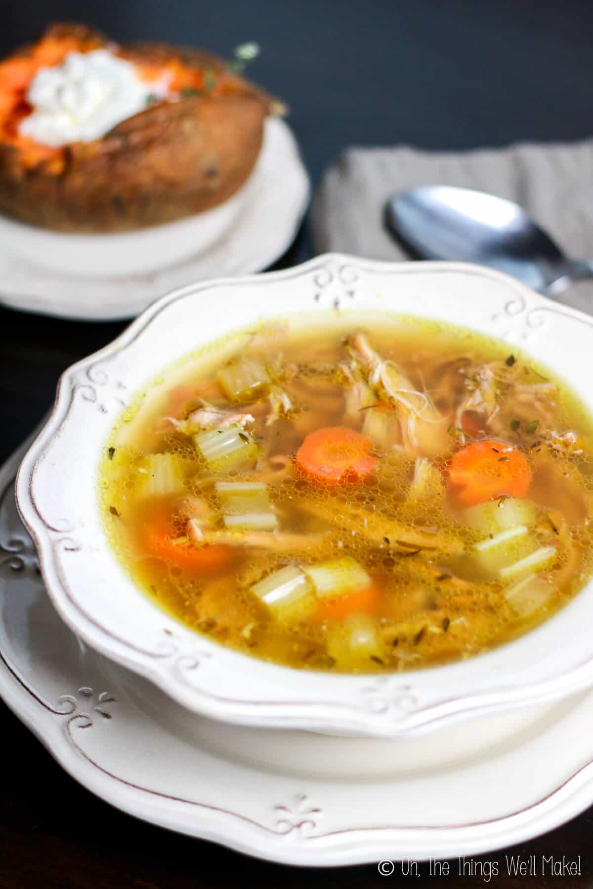 bowl of turkey rice soup served with baked sweet potato