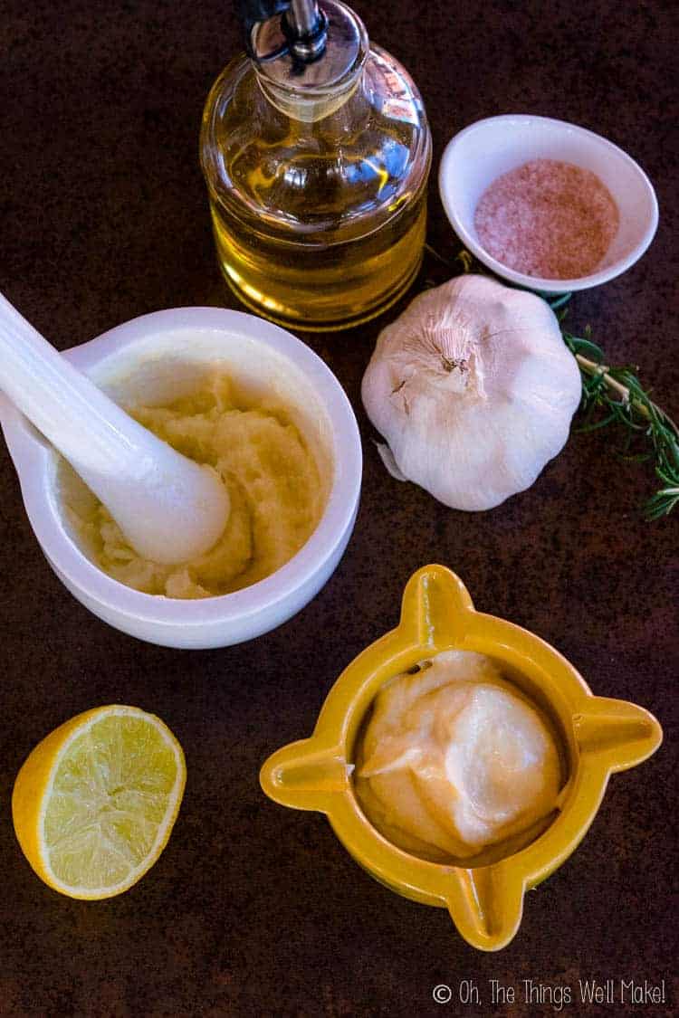 Traditional aioli in a white mortar next to modern aioli in a yellow mortar.