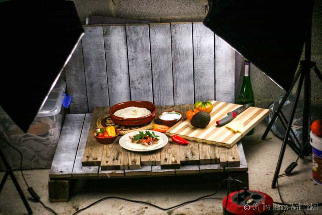 A homemade pallet "studio" with artificial lights set up to take pictures of homemade carnitas.