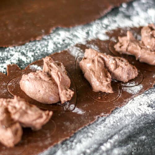 Placing a chocolate mascarpone filling within the marks made in a heart shape on the pasta