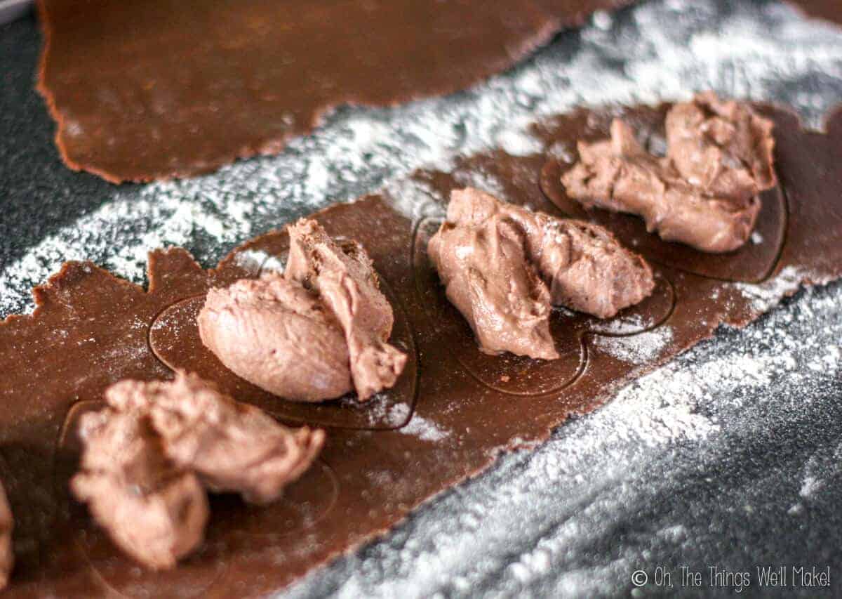 Placing a chocolate mascarpone filling within the marks made in a heart shape on the pasta