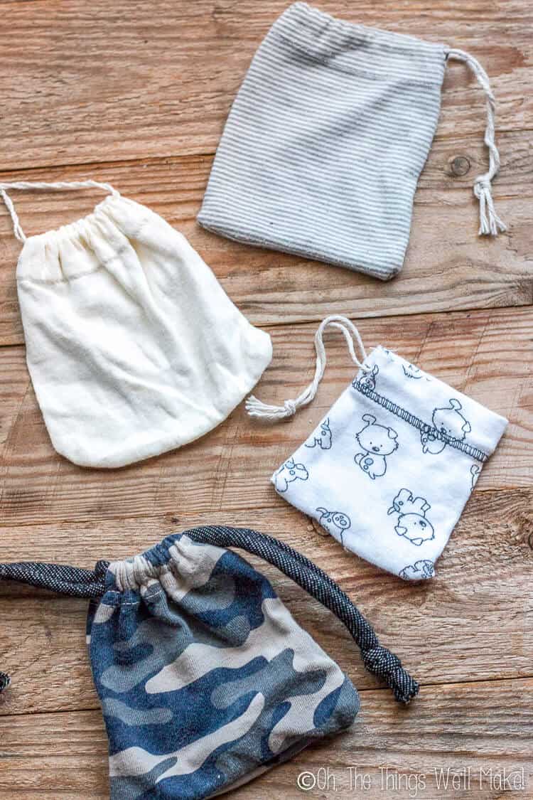 photo of 4 different drawstring pouches made form the sleeves of baby clothes