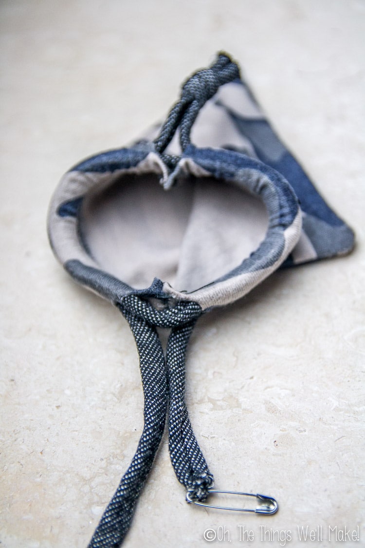Pulling the cording through for a double drawstring bag
