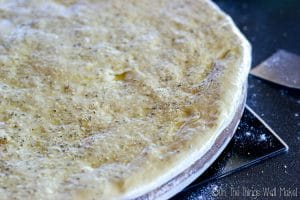 Pizza dough brushed with olive oil and sprinkled with herbs