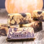 Closeup of marbled cream and brown pumpkin spice soap with the words "pumpkin spice soap" pressed into the front bar.