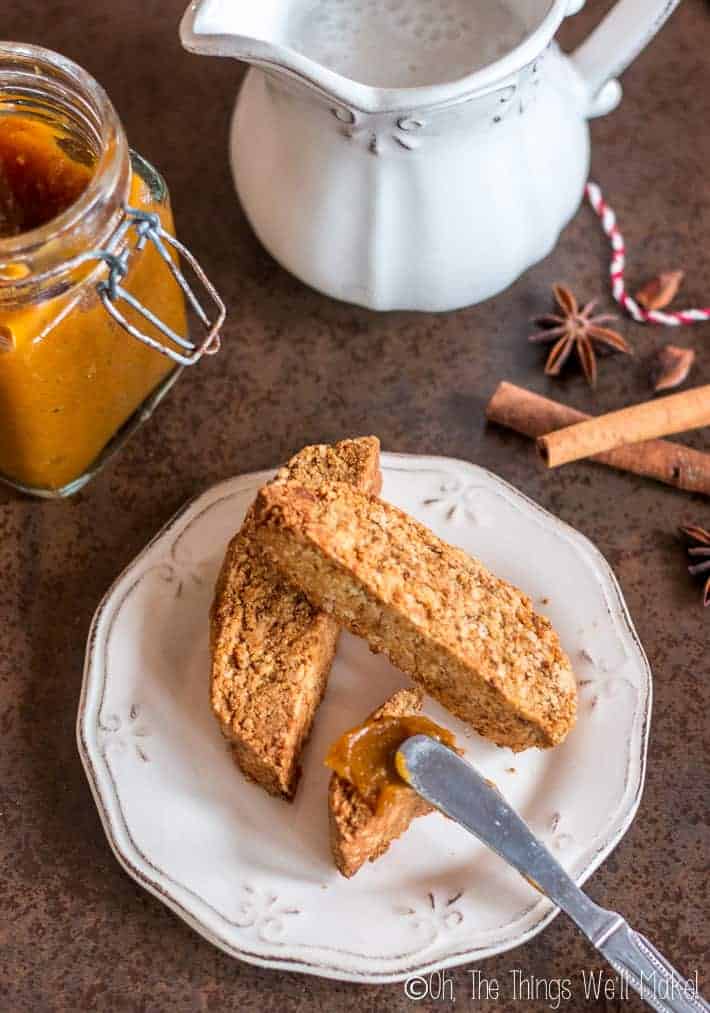 spreading spiced pumpkin butter over pumpkin spice biscotti