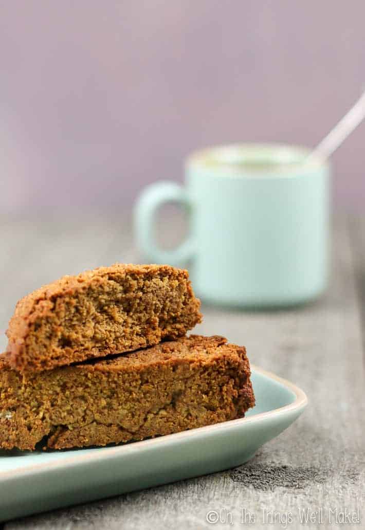 My original pumpkin spice biscotti on a plate in front of a cup of coffee.