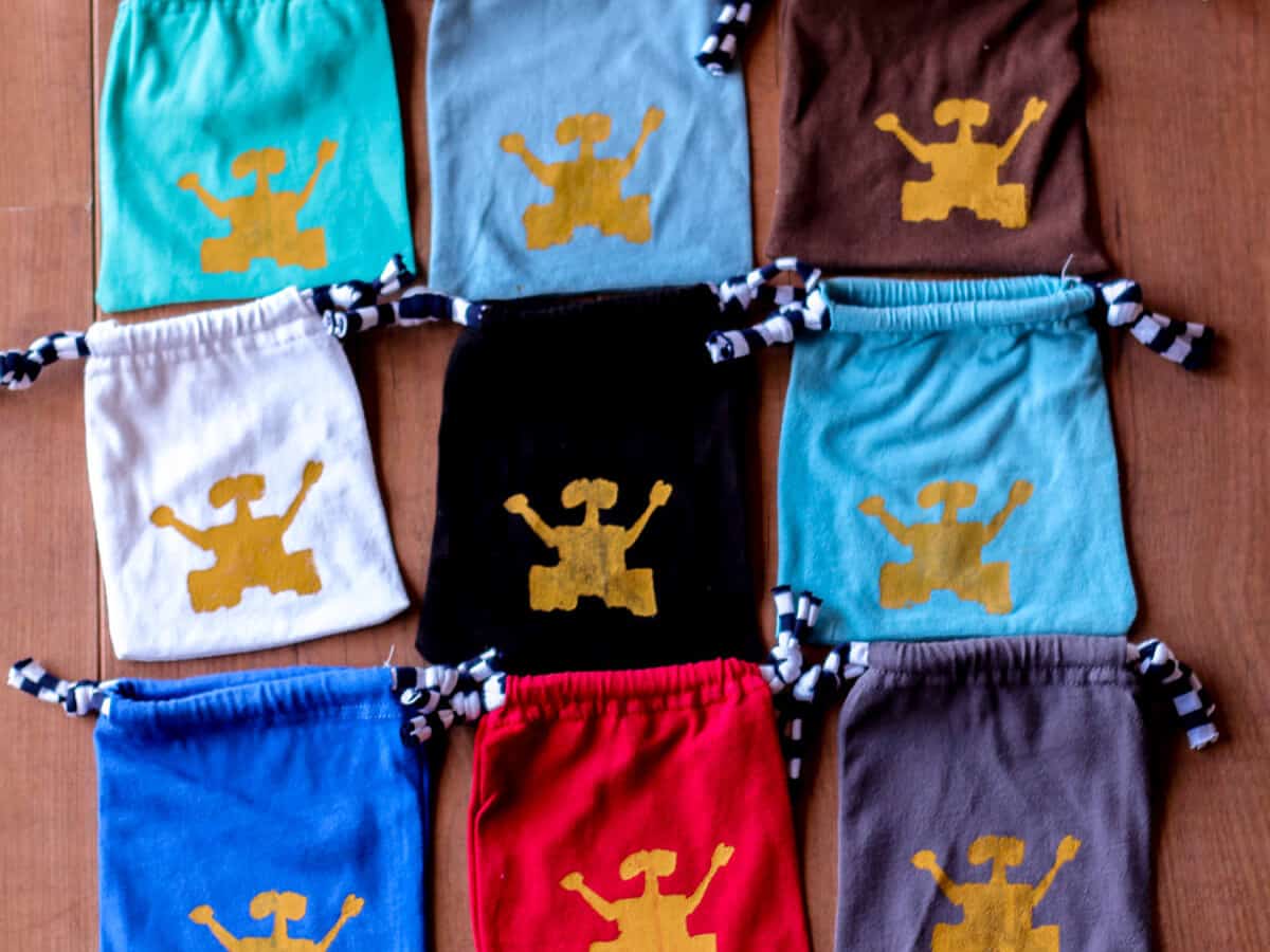 Overhead view of 9 cloth pouches with Wall-E silk screened on them