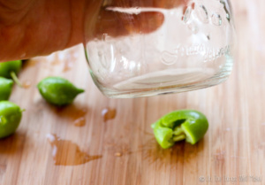 Smashing an olive with the bottom of a glass jar