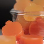 A bowl of pumpkin shaped gummy treats made with fruits and vegetables