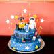 A Star Wars themed two layer birthday cake covered in blue fondant and decorated with white and yellow stars with wall-e and eve on top.