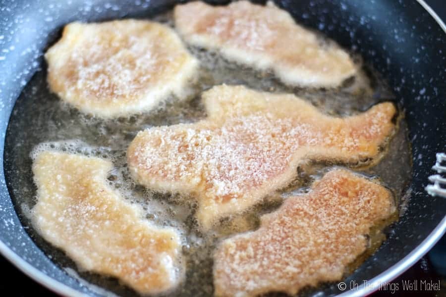 Frying Halloween shaped breaded chicken nuggets in oil