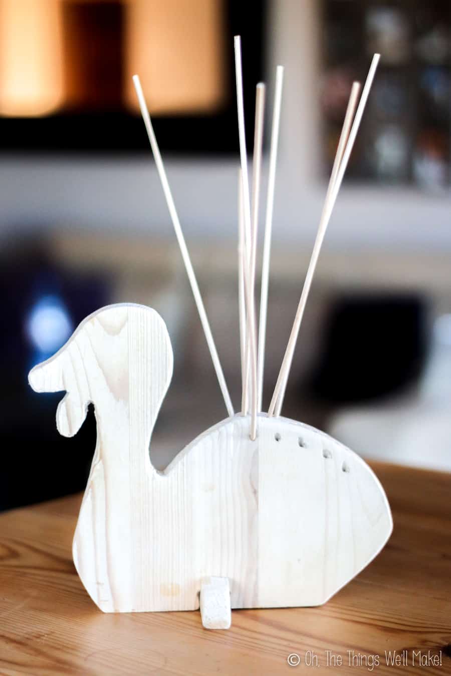 A wooden turkey display holding some bamboo skewers