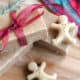 Overhead view of 3 bars of homemade gingerbread soap with some mini gingerbread man shaped soaps