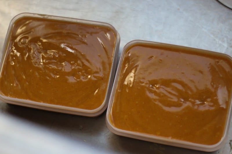 Two plastic molds filled with homemade gingerbread soap mixture