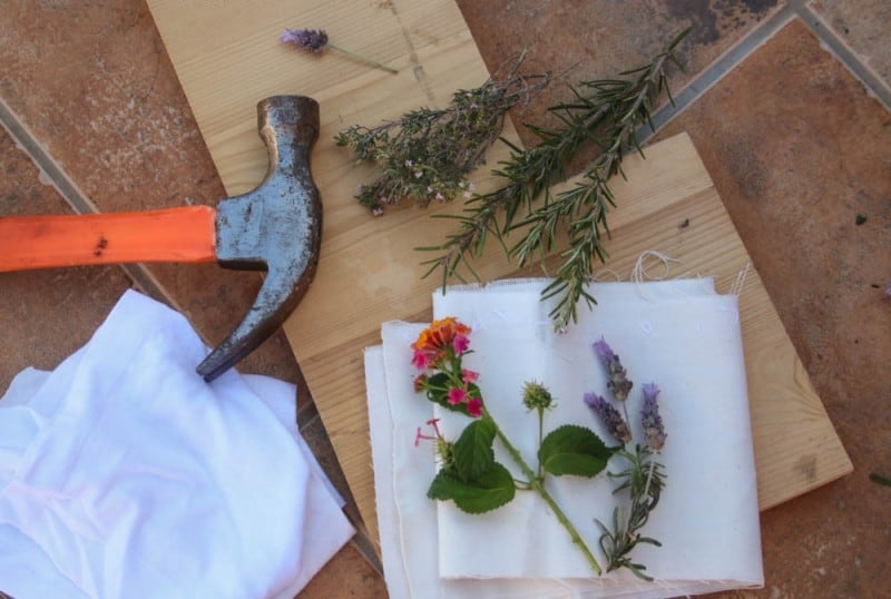 Overhead view of a hammer, flowers, and cloth