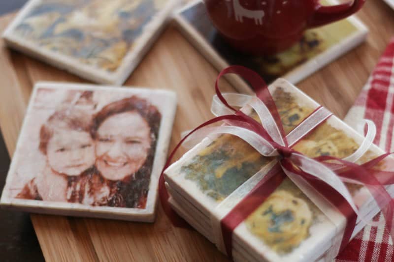 A stack on homemade marble coasters tied with a ribbon, surrounded by other homemade marble coasters