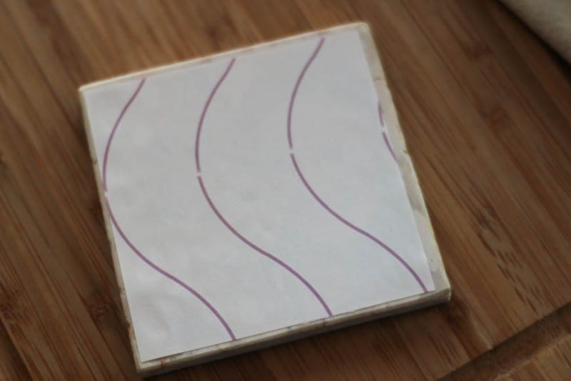 A t-shirt transfer ironed onto a marble tile (backing paper side up)