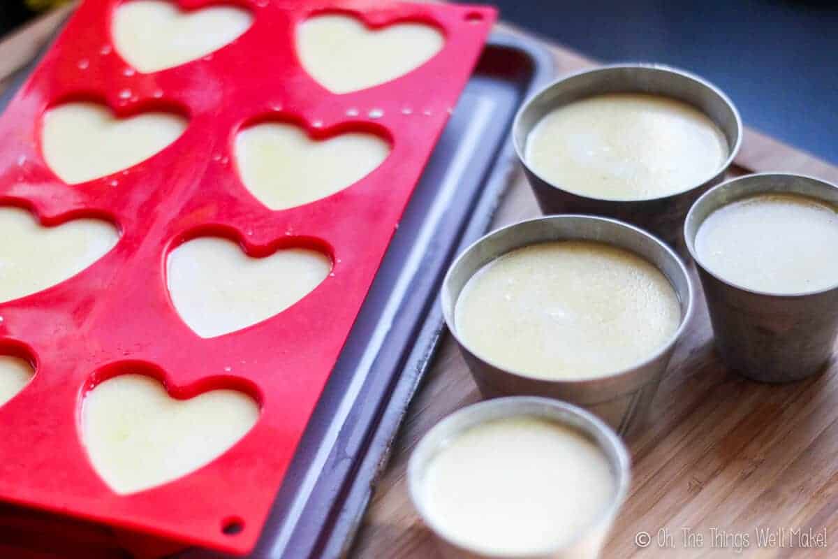 panna cotta mixture in aluminum flan molds and silicone heart shaped molds