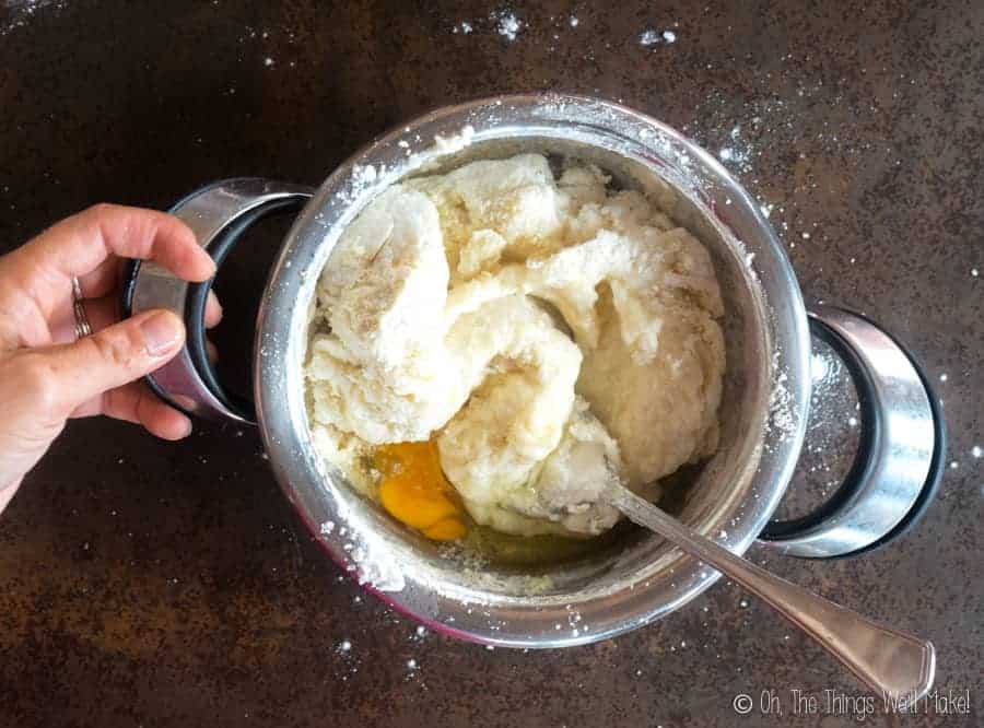 mixing an egg into a gluten-free churros dough
