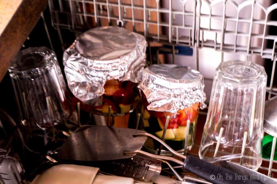 Salmon in jars in the dishwasher, ready for cooking there.