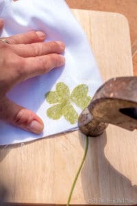 Tapping over the cloth covered clover with a hammer. You can see the dye seeping through.