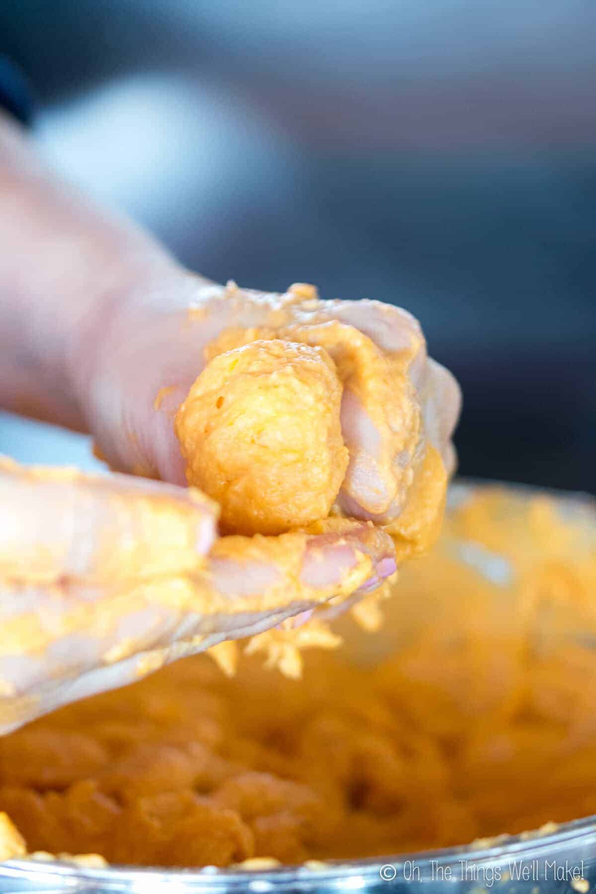 Forming a round shape of pumpkin fritter dough.