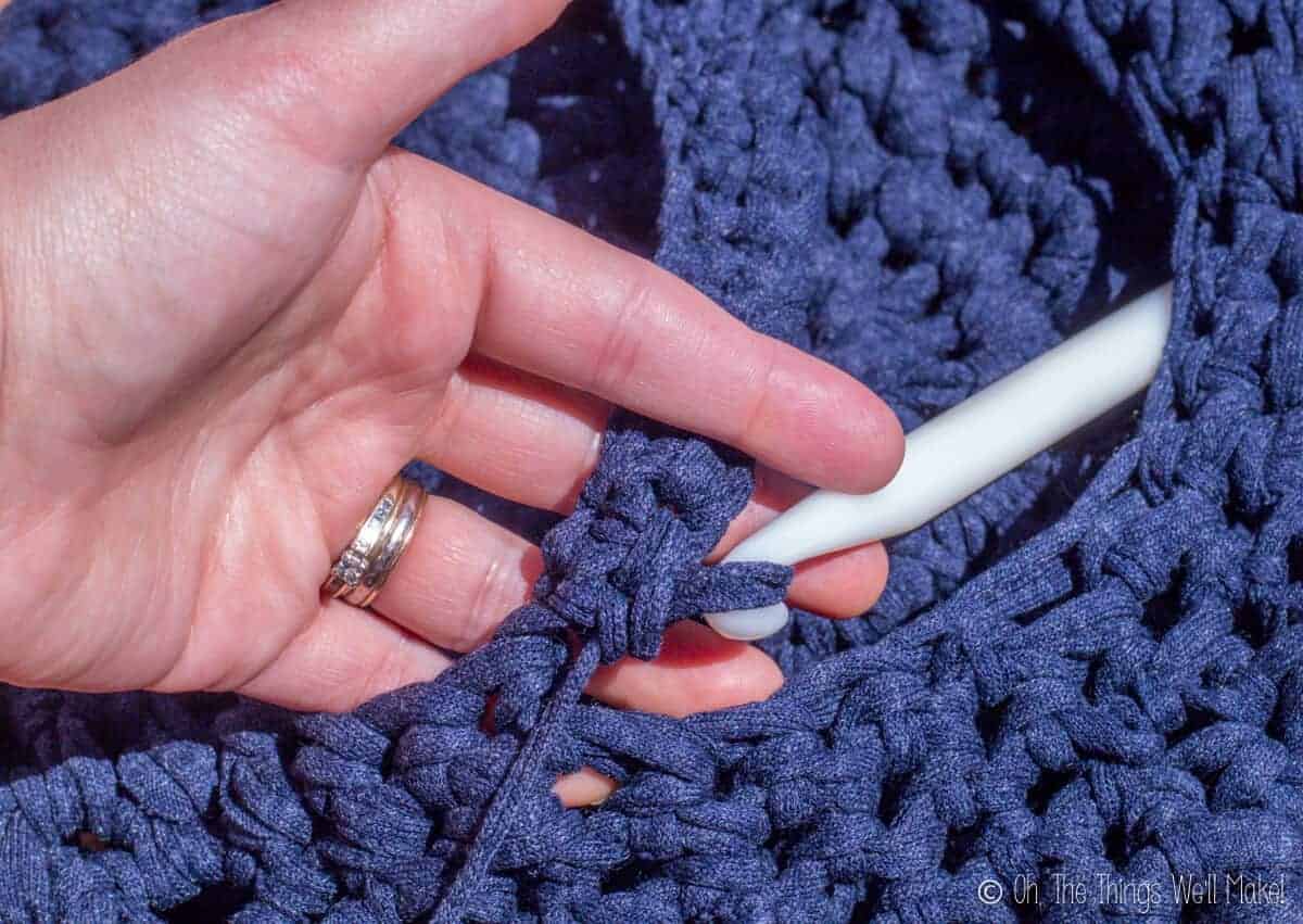 attaching the second row of the handle to the other side of the crochet Easter basket