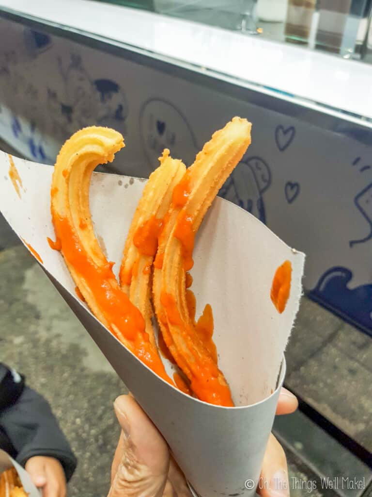 Churros served with salsa brava