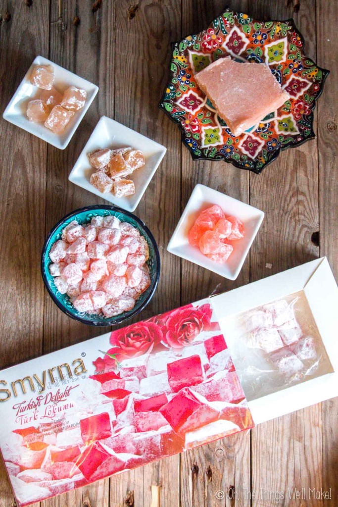 Overhead view of a box of Turkish delight next to several bowls filled with homemade Turkish delight.